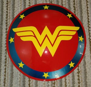A red and yellow wonder woman logo on top of a wall.