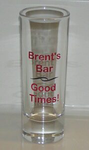 A glass with the words " brent 's bar good times !" written on it.
